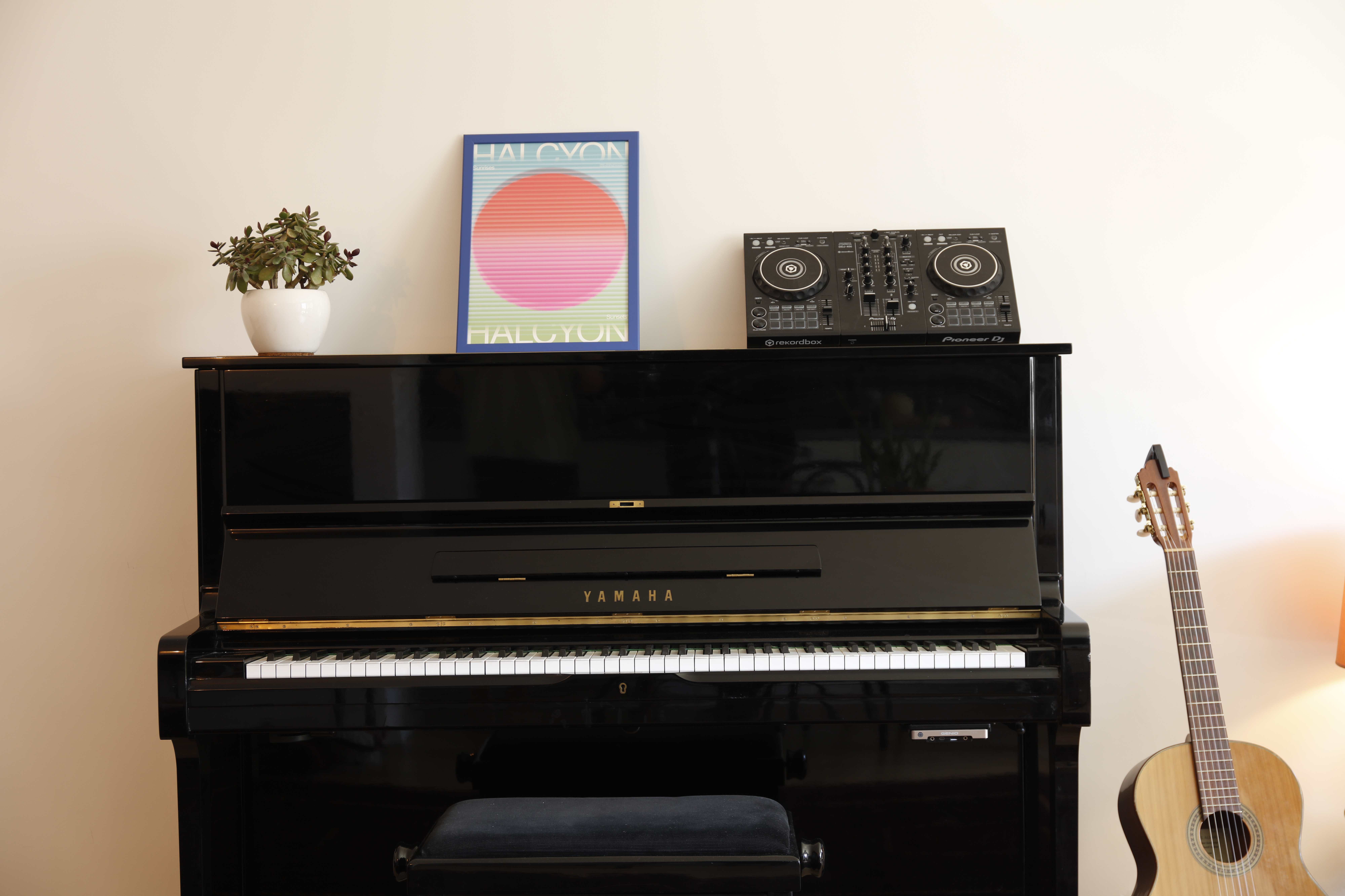 Full studio view with piano and guitar